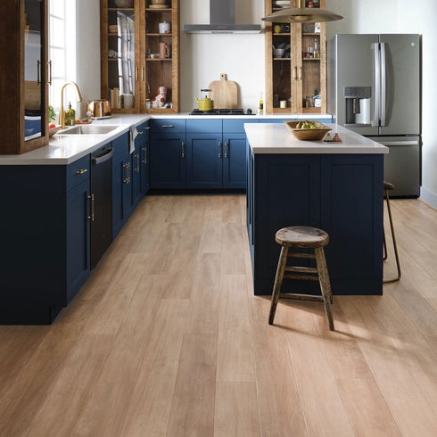 Photo of Tawny Beech COREtec luxury vinyl flooring. 7" wide. Installed in kitchen.